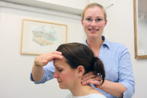 Attend2Health Louise Hampton Chiropractor palpating the neck to feel for any locked joints